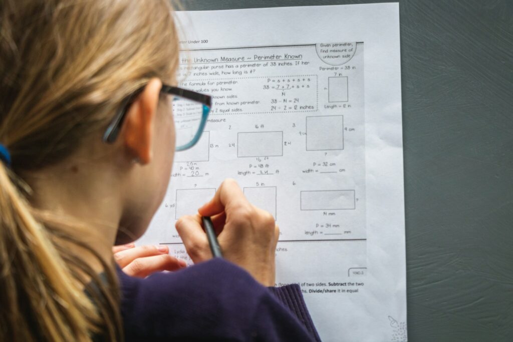 woman in black framed eyeglasses holding pen How to Become a Project Manager